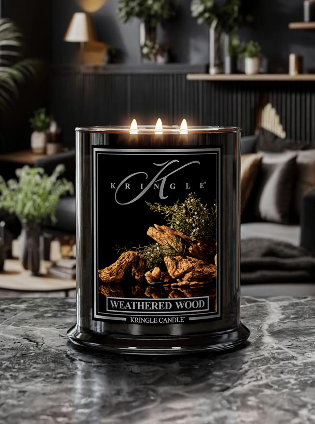 Kringle Candle in Weathered Wood scent on a marble surface with a cozy indoor background.
