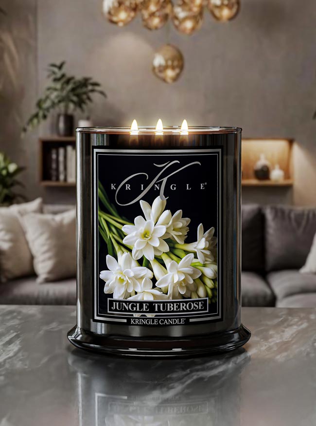 Kringle Candle with 'Jungle Tuberose' fragrance on a table in a cozy living room.