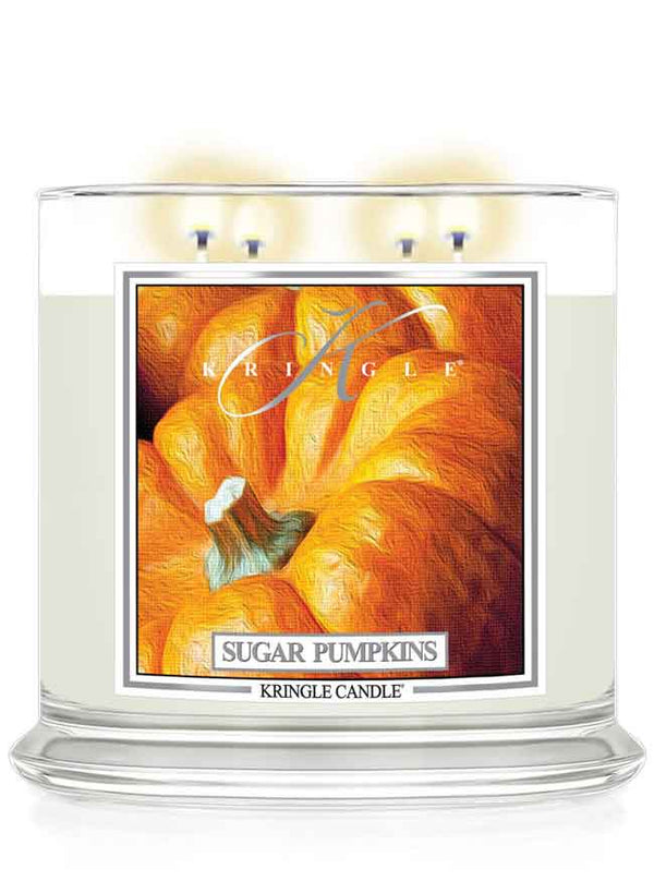 Kringle Candle Sugar Pumpkins 4-wick lit candle with a pumpkin design on the label.