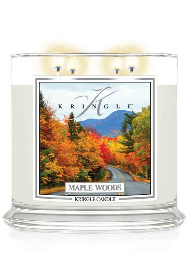 Kringle Candle Maple Woods scented 4-wick lit candle with a fall scene label on a white background