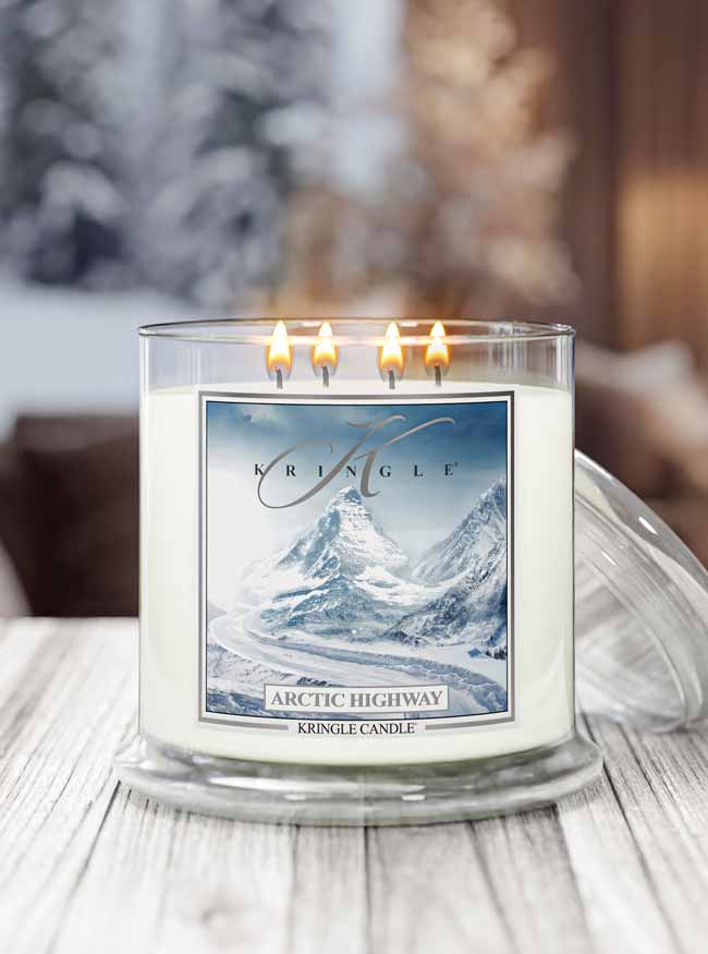 Kringle Candle Arctic Highway candle with mountain design on a wooden surface