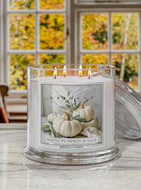 Kringle Candle with 'White Pumpkin & Sage' label on a lifestyle kitchen autumn trees window background