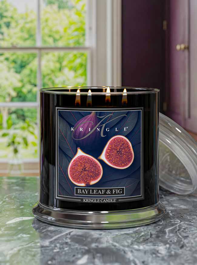 Kringle Candle with 'Bay Leaf & Fig' label on a kitchen counter surface with a window in the background