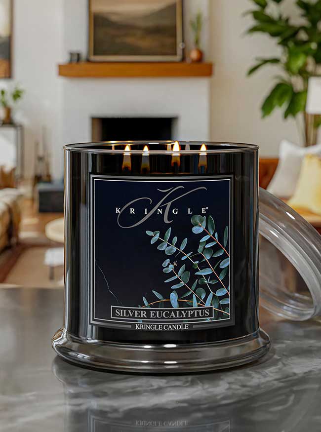 Kringle Candle Silver Eucalyptus candle on a marble surface with a home interior background