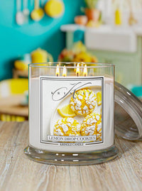 Kringle Candle lemon drop cookies scented candle on a wooden surface with a kitchen background.