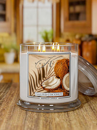 Kringle Candle salted coconut candle on a wooden surface with a blurred kitchen background