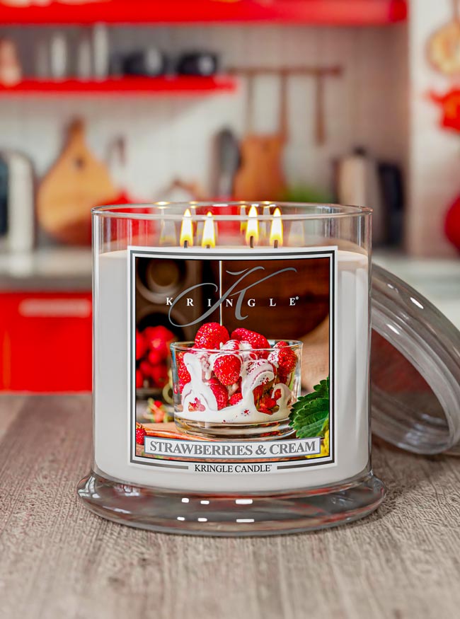 Kringle Candle with 'Strawberries & Cream' label on a wooden surface
