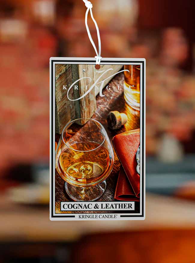 Kringle Candle Cognac & Leather air freshener with a blurred background