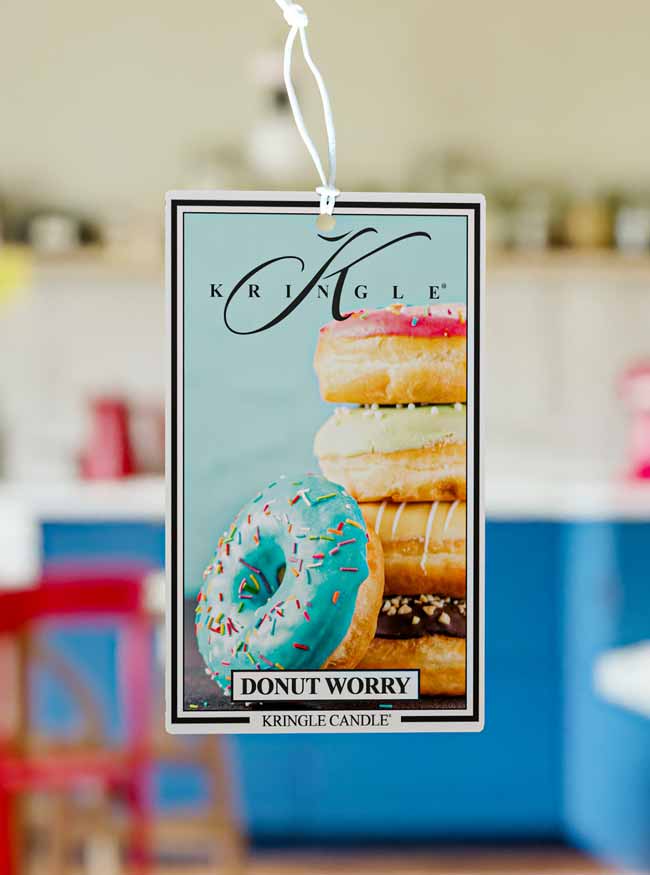 Kringle Candle air freshener with donut design on a blurred background