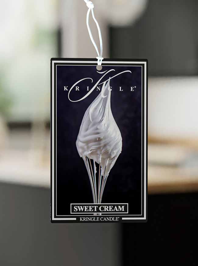 Kringle Candle Sweet Cream air freshener with a blurred background