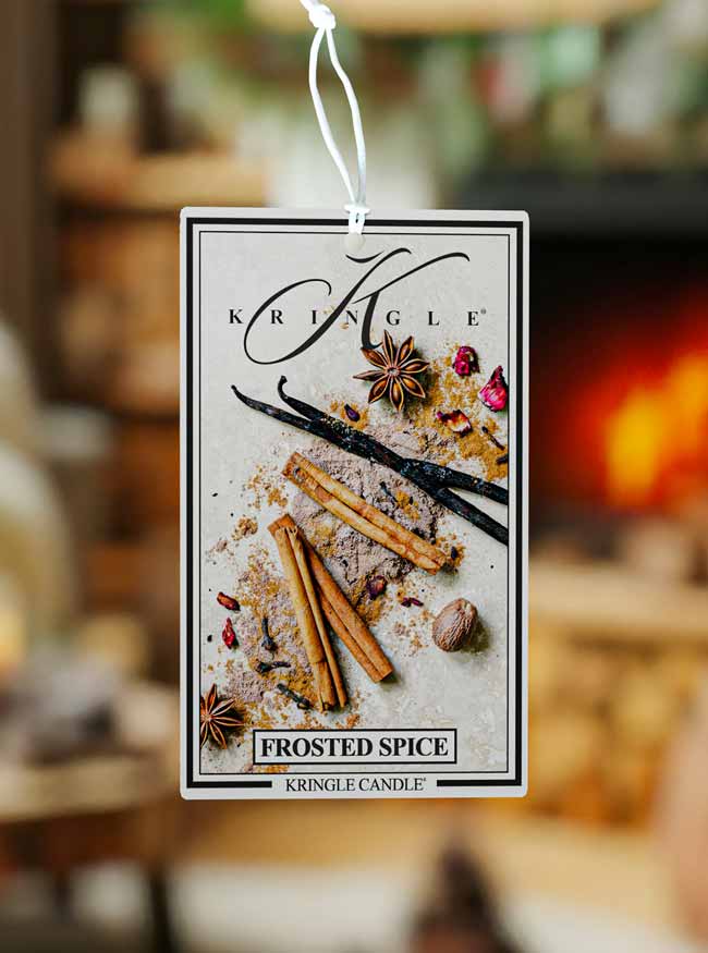 Kringle Candle Frosted Spice hanging air freshener with a blurred background