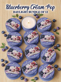 Collection of 12 Country Candle Bluerberry Cream Pop daylight candles on a wooden surface with blueberries.