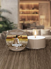Kringle Candle Far Far Away daylight candle with packaging on a wooden surface