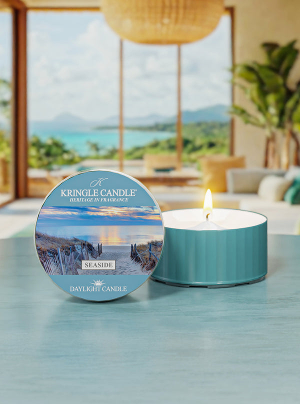 Kringle Candle Seaside daylight candle on a table with a scenic background