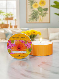Kringle Candle daylight candle with floral design on a marble surface in a home setting.