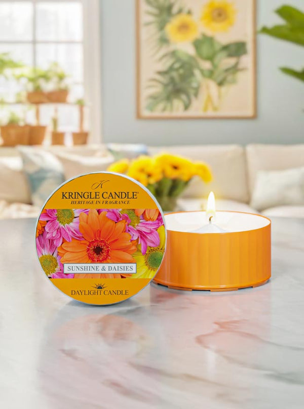 Kringle Candle daylight candle with floral design on a marble surface in a home setting.