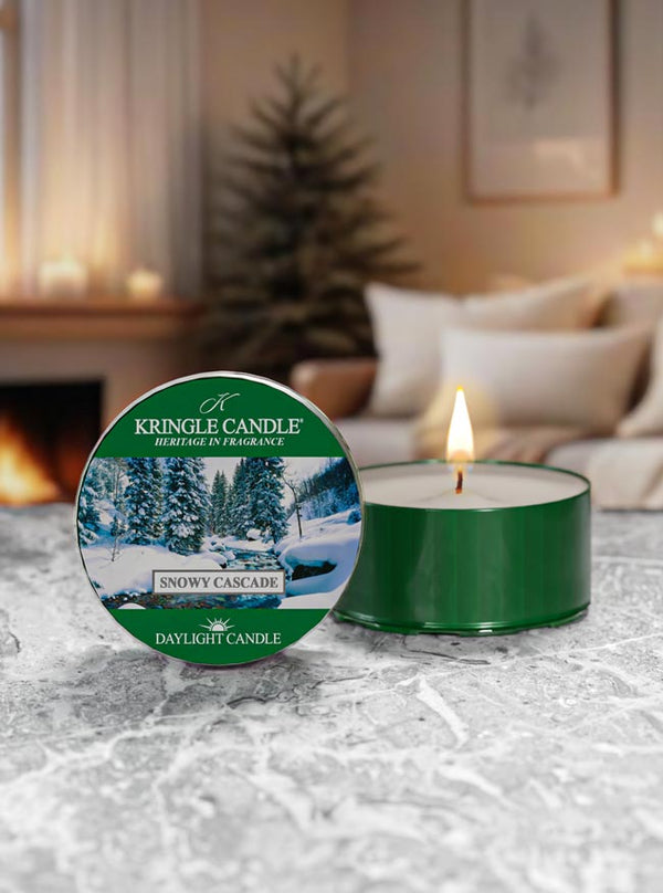 Snowy Cascade  candle with Kringle Candle packaging on a textured surface with a cozy indoor background.