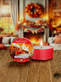 Whiskey & Embers red DayLight candle, featuring a label with whiskey glasses and a fireplace in the background.