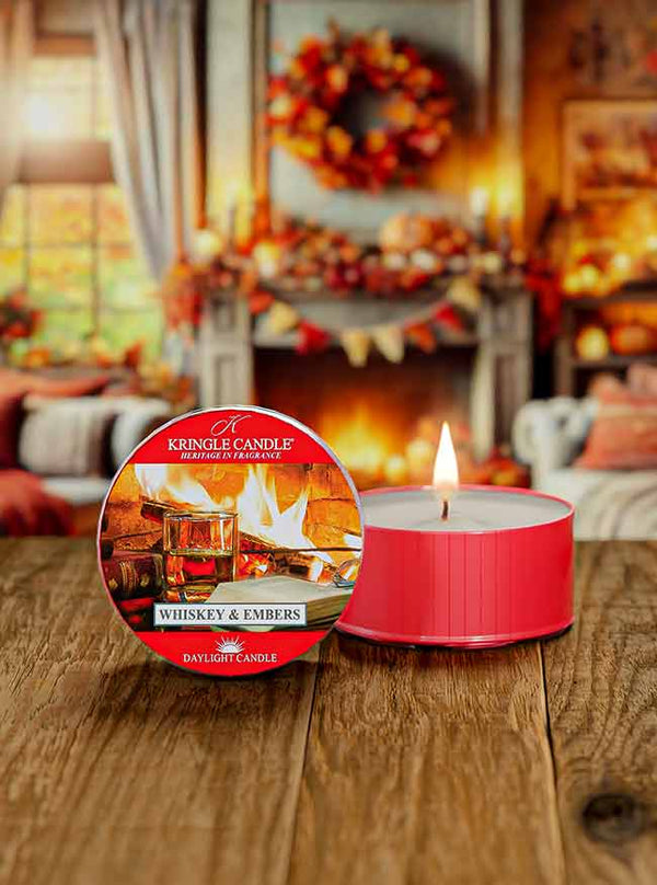 Whiskey & Embers red DayLight candle, featuring a label with whiskey glasses and a fireplace in the background.
