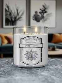 Lit Candle with a label titled Divine Clarity in a living room setting