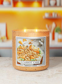 Kringle Candle Carrot Cake candle on a kitchen counter with blurred background