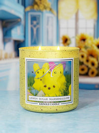 Kringle Candle with lemon sugar marshmallow flavor on a blue surface with sunflower background