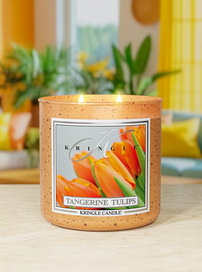 Kringle Candle Tangerine Tulips candle on a table with a blurred indoor background