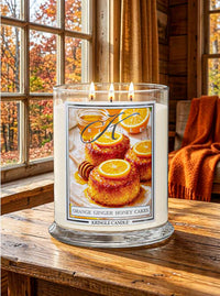 Kringle Candle lifestyle photo featuring Orange Ginger Honey Cakes Candle on a wood table and fall decor.