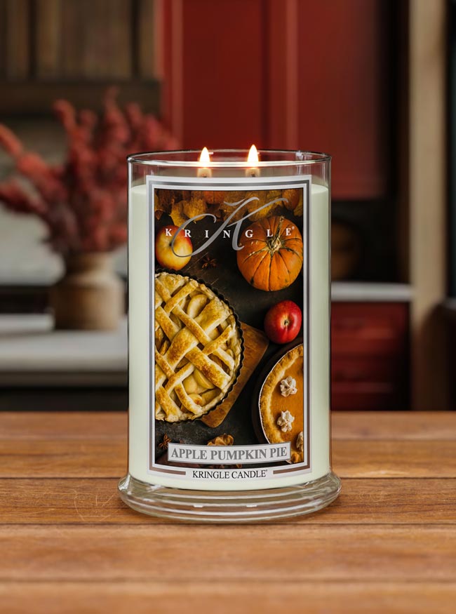 Kringle Candle with 'Apple Pumpkin Pie' design on a wooden surface