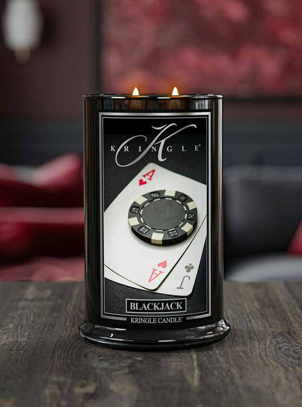 Kringle Candle with poker chip and card design on a wooden surface