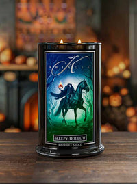 Kringle Candle with 'Sleepy Hollow' design on a wooden surface with Halloween-themed background