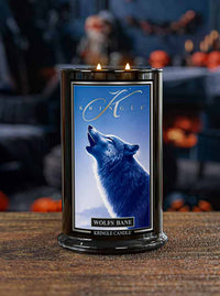 Lit Halloween candle  on wood base labeled "Wolf's Bane" with an image of a howling wolf under a blue sky.