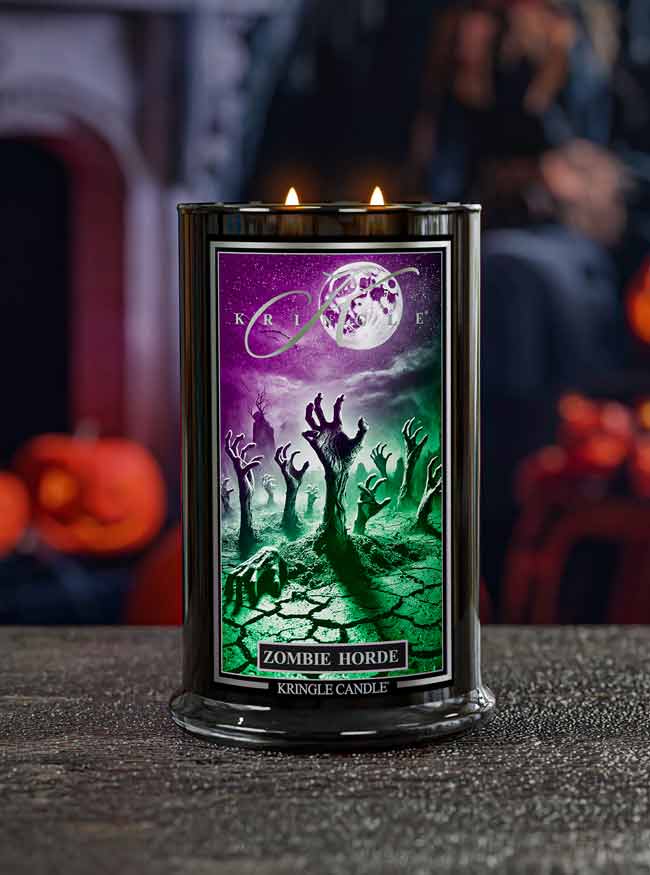 Kringle Candle Zombie Horde candle with a Halloween-themed label on a dark surface.