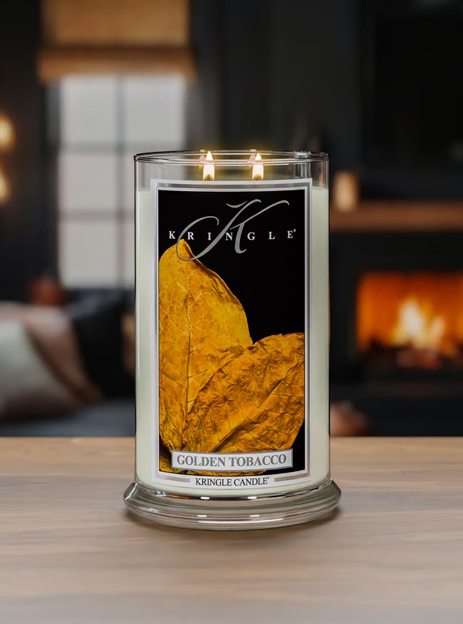 Kringle Candle with 'Golden Tobacco' label on a wooden surface with a blurred background