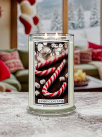 Kringle Candle 'Candy Cane Lane' in a glass jar with a festive background.