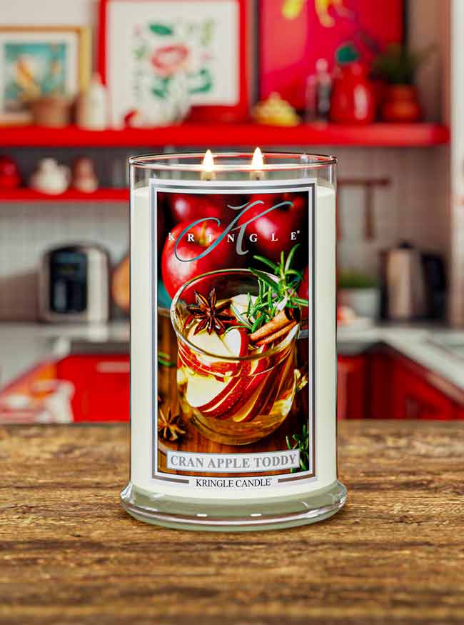 Kringle Candle with cranberry apple toddy design on a wooden surface