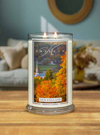 Kringle Candle with New England design on a wooden surface