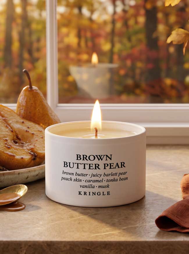 Brown Butter Pear Mini Candle Tin on a table Lifestyle photo with pears and fall leaves window background.