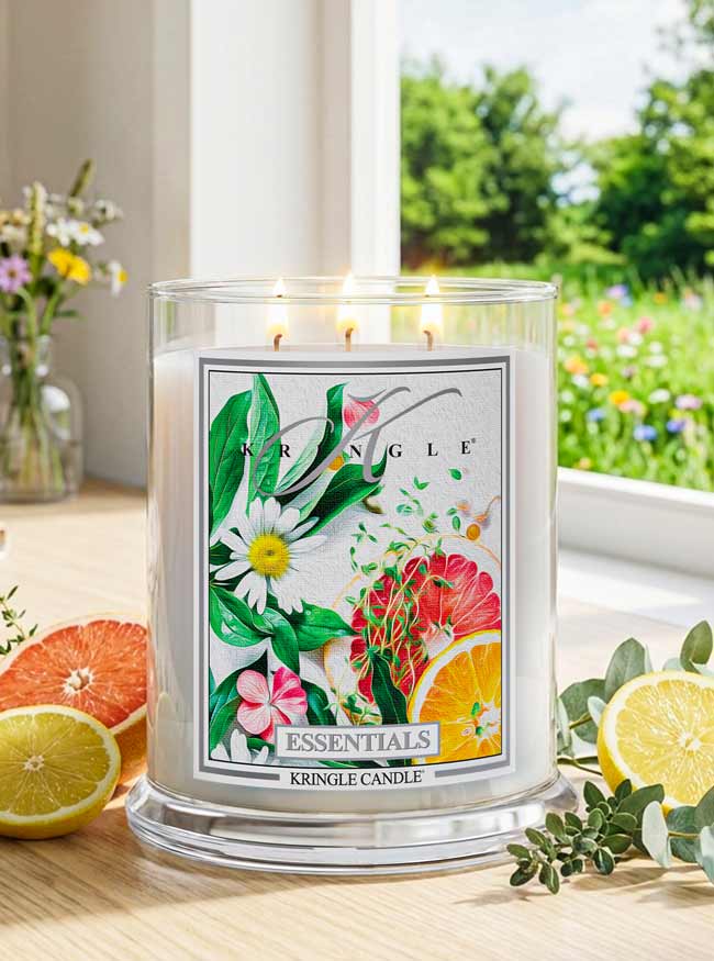 Kringle Candle with floral design on a table with fruits and flowers
