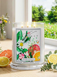 Kringle Candle with floral design on a table with fruits and flowers