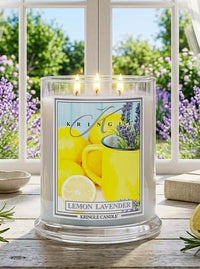 Kringle Candle Lemon Lavender candle on a windowsill with a view of greenery outside.