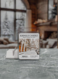 Kringle Candle wax melts packaging on a surface with a blurred background of a cozy room.