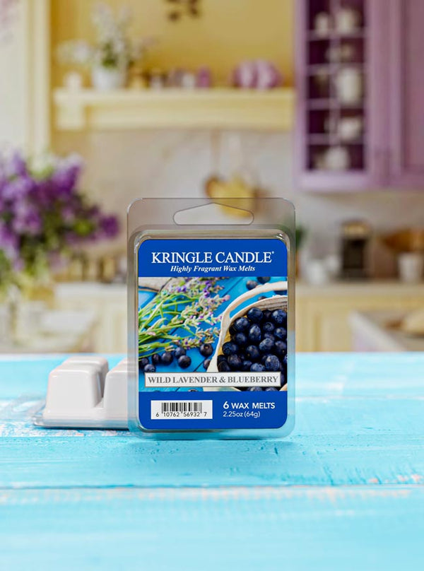 Kringle Candle Wild Lavender & Blueberry wax melts packaging on a blue surface with a blurred kitchen background.