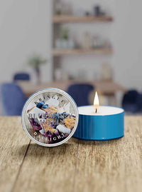 Blueberry Muffin daylight candle with a label on a wooden surface, blurred background
