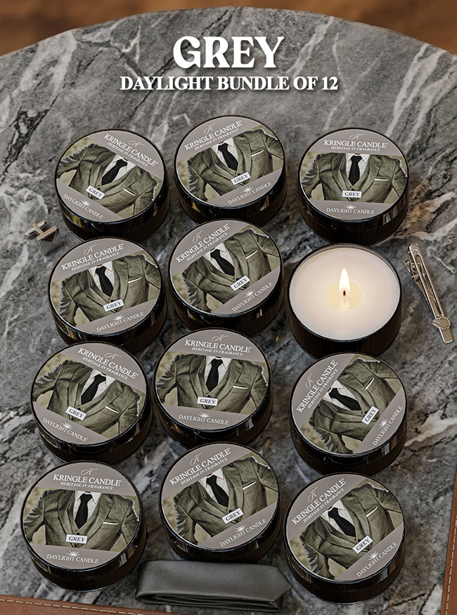 Bundle of 12 Kringle Candle Grey Daylight candles on a marble surface