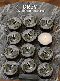 Bundle of 12 Kringle Candle Grey Daylight candles on a marble surface