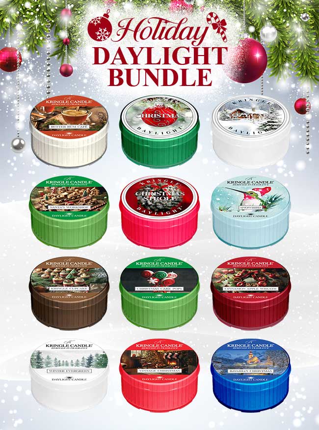 A variety of Kringle branded holiday daylight candles arranged on a surface with Christmas decorations around. The candles are in different labels, each with a different holiday fragrance indicated offered at a bundle price.