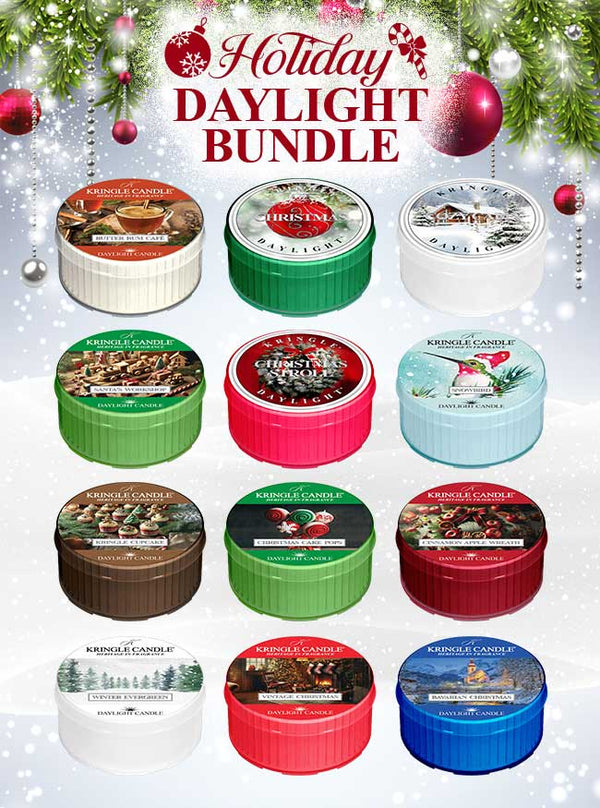 A variety of Kringle branded holiday daylight candles arranged on a surface with Christmas decorations around. The candles are in different labels, each with a different holiday fragrance indicated offered at a bundle price.