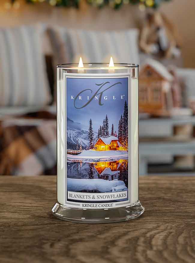 Blankets & Snowflakes large 2-wick jar with a blurred home background.