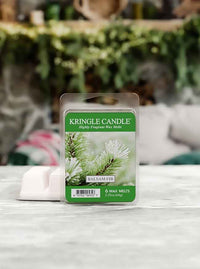 Kringle Candle Balsam Fir wax melt package on a surface with a blurred background